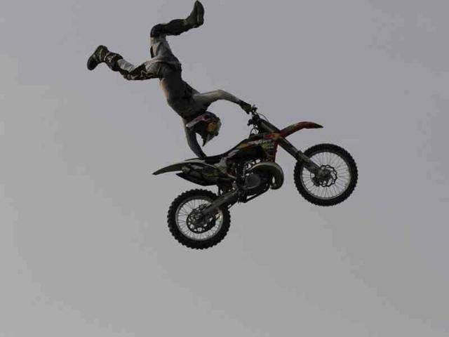 Motor bikers are doing stunts during Red Bull X-Fighters Freestyle Motocross (FMX) motorbike stunt competition, in New Delhi, India. (Hindustan Times Photo/Virendra Singh Gosain)