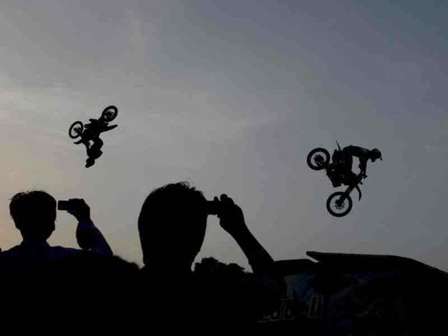 Motor bikers are doing stunts during Red Bull X-Fighters Freestyle Motocross (FMX) motorbike stunt competition, in New Delhi, India. (Hindustan Times Photo/Virendra Singh Gosain)
