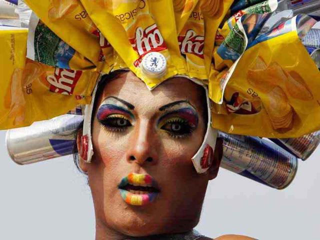 A reveller waits on the top of a bus to take part in the Gay Pride parade in Lima. Reuters/Mariana Bazo
