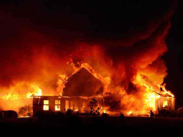 A two-alarm fire started by a lightning strike from a thunderstorm engulfs a home north of Frederick. AP/Sam Yu