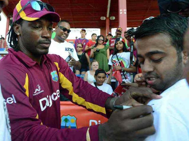 West Indies cricketer Chris Gayle signs autographs for fans at the end of the first T20 match between West Indies and New Zealand at the Central Broward Regional Park Stadium Turf Ground in Lauderhill, Florida. West Indies won by 56 runs. AFP/Jewel Samad