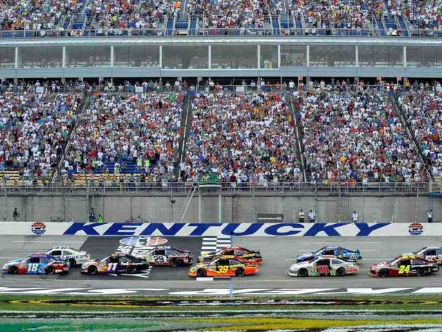 Jimmie Johnson, driver of the #48 Lowe's Dover White Chevrolet, and Kyle Busch, driver of the #18 Red-White-Blue Toyota, lead the field past the green flag to start the NASCAR Sprint Cup Series Quaker State 400 at Kentucky Speedway in Sparta, Kentucky. AFP/Rainier Ehrhardt