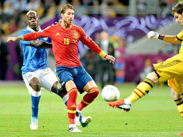 Spanish defender Sergio Ramos (C) protects Spanish goalkeeper Iker Casillas (R) from Italian forward Mario Balotelli during the Euro 2012 football championships final match Spain vs Italy at the Olympic Stadium in Kiev. (AFP Photo/Gabriel Bouys)