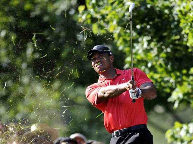 Tiger Woods chips onto the 16th fairway during the final round of the AT&T National golf tournament at Congressional Country Club in Bethesda, Md. (AP Photo)