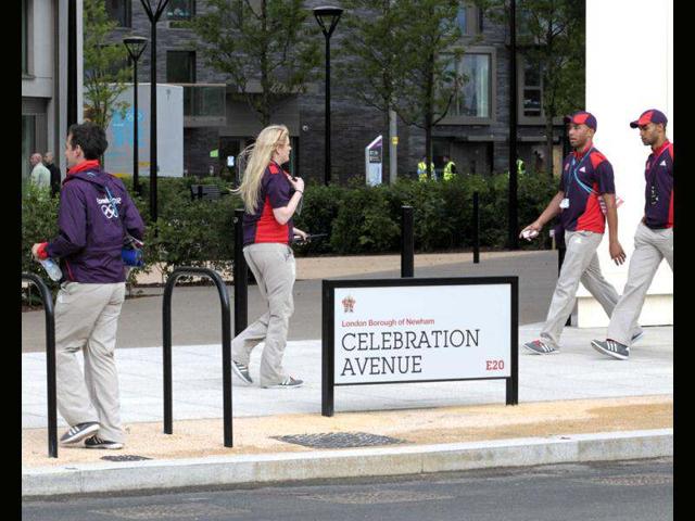 LOCOG employees cross Celebration Avenue in the Olympic Village built for the London 2012 Olympic Games in Stratford, east London. The village will accomodate up to 16,000 athletes and officials from more than 200 nations. Reuters/Olivia Harris
