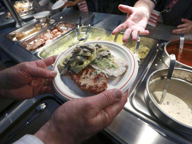 Food is served in the 5,000 capacity Olympic Village dining room, a temporary structure built for the London 2012 Olympic Games, during a test of the facilities in Stratford, east London. The village will accomodate up to 16,000 athletes and officials from more than 200 nations. Reuters/Olivia Harris