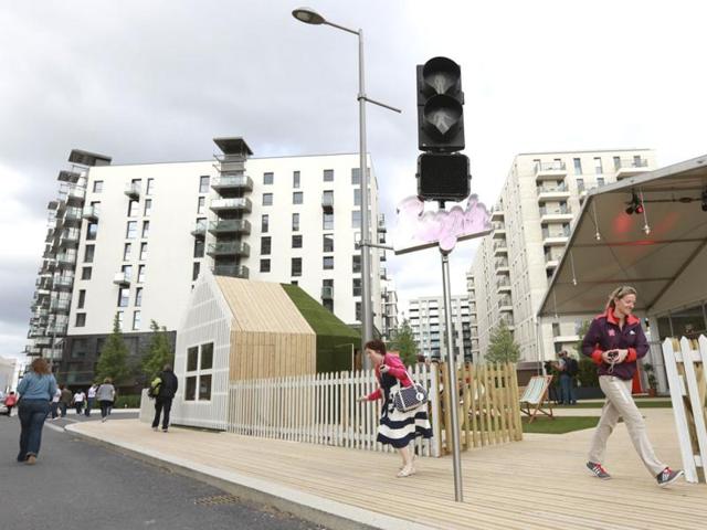 Guests and staff walk outside the Globe bar in the Olympic Village built for the London 2012 Olympic Games in Stratford, east London. The Globe will be a dry bar for the duration of the games. The village will accomodate up to 16,000 athletes and officials from more than 200 nations. Reuters/Olivia Harris