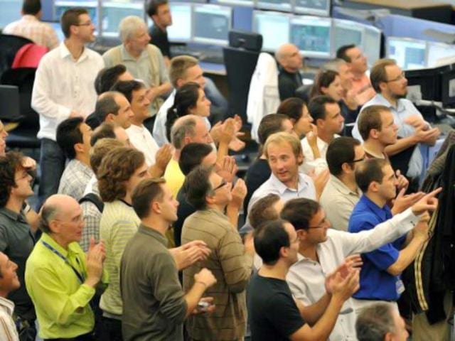 European Organisation for Nuclear Research (CERN) scientists applaud at the CERN's control center near Geneva during the switch on operation of the Large Hadron Collider (LHC), the world's biggest atom-smasher in a mission to answer some of the most perplexing questions of the physical universe. AFP/Fabrice Coffrini/Pool, File