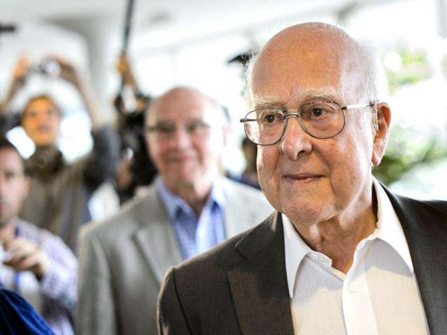British physicist Peter Higgs arrives for the opening of a seminar to deliver the latest update in the 50-year bid to explain a riddle of fundamental matter in the search for a particle called the Higgs boson at CERN in Meyrin, near Geneva. AFP photo/Fabrice Coffrini
