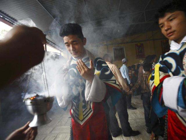 Tibetans dressed in traditional attire takes blessings from the rising smoke of incense while participating in the 77th birthday celebrations of exiled spiritual leader the Dalai Lama in Kathmandu. Nepal ceased issuing refugee papers to Tibetans in 1989 and recognizes Tibet to be a part of China. (Reuters)