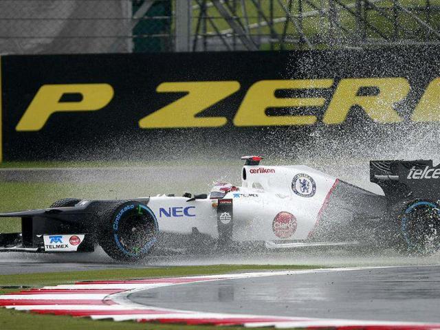 Japan's Kamui Kobayashi driving a Sauber-Ferrari Formula 1 car in action during practice at the Silverstone circuit, England. The Formula 1 teams make preparations ahead of the British Grand Prix at Silverstone circuit on Sunday. (AP Photo/Tim Hales)