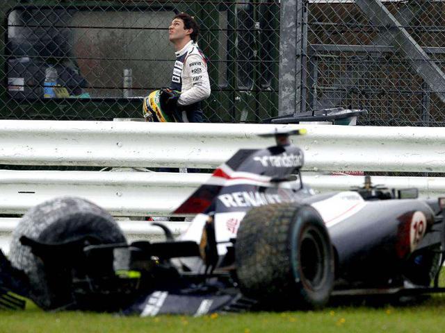 Williams Formula One driver Bruno Senna of Brazil looks at rain clouds after crashing his car during the second practice session of the British F1 Grand Prix at Silverstone, central England. Rain and traffic chaos put a dampener on practice for the British Grand Prix on Friday with McLaren's Lewis Hamilton doing his best to raise the spirits of drenched home fans with the fastest lap of the day. REUTERS/Chris Helgren