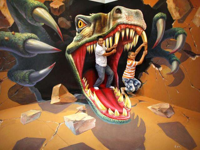 A man with his son pose for a photograph in front of a 3D painting at the 2012 Magic Art Special Exhibition in Hangzhou. Reuters/Carlos Barria