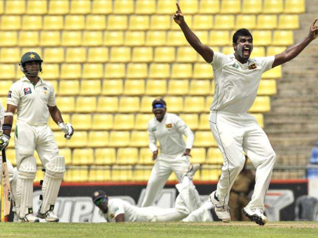 Sri Lankan bowler, Thisara Perera, successfully appeals for the wicket of Pakistan's batsman Taufeeq Umar during the first day of their third test cricket match in Pallekele, Sri Lanka. AP Photo