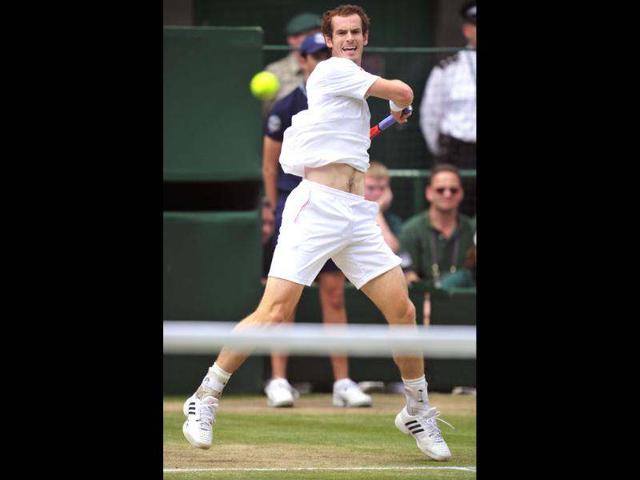 Britain's Andy Murray plays a shot during his men's singles final match against Switzerland's Roger Federer on day 13 of the 2012 Wimbledon Championships tennis tournament at the All England Tennis Club in Wimbledon, southwest London. AFP/Glyn Kirk