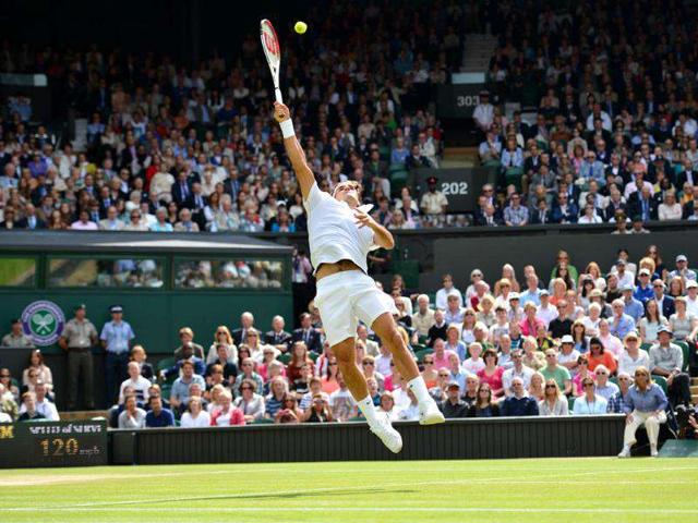 Switzerland's Roger Federer jumps to play a shot during his men's singles final match against Britain's Andy Murray during Wimbledon Championships tennis tournament at the All England Tennis Club in Wimbledon, southwest London. AFP/Leon Neal