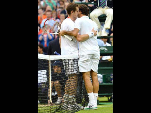 Switzerland's Roger Federer embraces Britain's Andy Murray after his men's singles final victory during Wimbledon Championships tennis tournament at the All England Tennis Club in Wimbledon, southwest London. AFP/Leon Neal