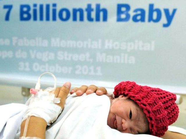 Danica Mae Camacho, the Philippine's symbolic 7 billionth baby is coddled by her mother Camille during a welcoming ceremony after she was born at a government-run maternity hospital in Manila on October 31, 2011. Africa and Asia will see the fastest urban population growth in the next 40 years, a UN report said earlier in the year noting that India and China are leading the surge. AFP/Ted Aljibe