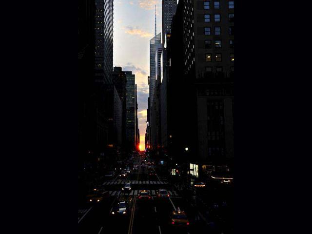 The sun sets over 42nd Street at the Park Avenue overpass in New York's Manhattan borough during a phenomenon known as Manhattanhenge. Manhattanhenge, sometimes referred to as the Manhattan Solstice, happens when the setting sun aligns with the east-to-west streets of the main street grid. The term references Stonehenge, at which the sun aligns with the stones on the solstices in England. (AP Photo/Jeffrey Furticella)