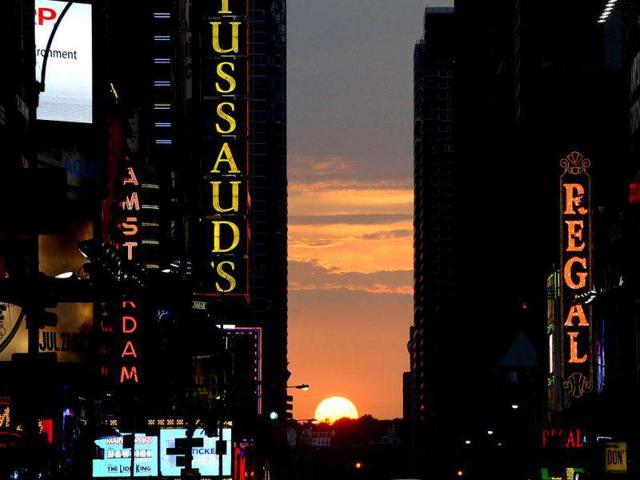The sun sets as seen from 42nd street in New York City, as Manhattanhenge, sometimes also referred to as Manhattan Solstice, the biannual natural event, when it is perfectly aligned with Manhattan’s numbered streets. AFP PHOTO / TIMOTHY A. CLARY