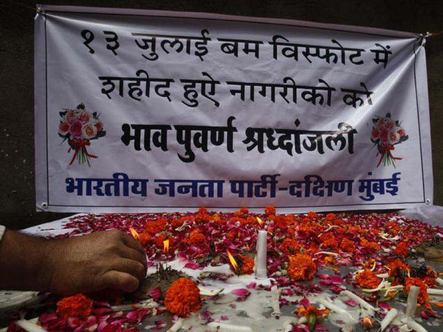People light candles as they pay homage at a memorial commemorating the first anniversary of the 13/7 serial blasts at the Opera House area of Mumbai. HT Photo/Kunal Patil