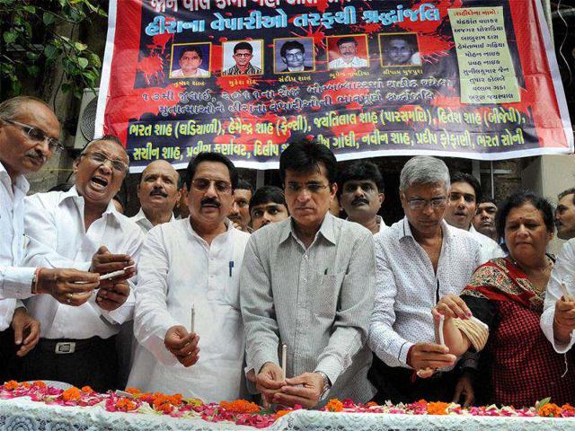 BJP leaders along with diamond merchants pay tributes to the victims of 13/7 serial blasts at Zaveri Bazar on the first anniversary of the bombing in Mumbai. PTI Photo