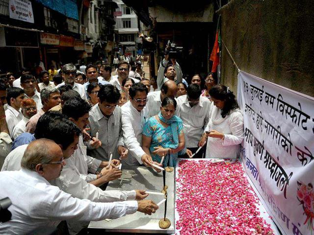 People light candles as they pay homage at a memorial commemorating the first anniversary of 13/7 serial blasts. AFP Photo/Punit Paranjpe