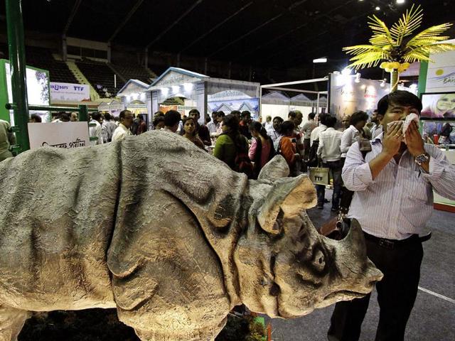 A visitor wipes his face as he walks past a figure of a rhinoceros at the 96th Travel and Tourism Fair in Kolkata. (AP Photo/Bikas Das) A visitor wipes his face as he walks past a figure of a rhinoceros at the 96th Travel and Tourism Fair in Kolkata. (AP Photo/Bikas Das)