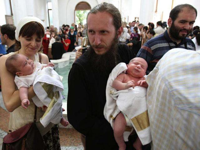 Babies are baptized during a mass baptism ceremony in the Holy Trinity Cathedral in Tbilisi, Georgia. (AP Photo/Shakh Aivazov)