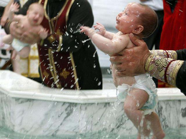 Babies are baptised during a mass baptism ceremony in Tbilisi. More than 12 thousand children were baptised by the Georgian Orthodox church at 23 mass baptism ceremonies at the country's main cathedral Holy Trinity. (Reuters Photo/David Mdzinarishvili)