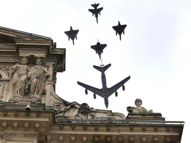 A French Boeing C135, refueling tanker and fighters aircrafts fly over the Louvre museum during the Bastille Day military parade in Paris. AFP/Kenzo Tribouillard