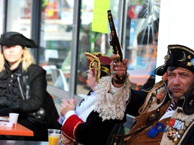 People disguised as pirates drink at a bar at the French western seaport of Brest as part of the 2012 Tonnerres de Brest maritime festival which features thousands of traditional sailboats.(AFP Photo/Alain Jocard)