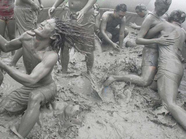 Tourists play with the mud during the 15th annual mud festival on Daecheon Beach in Boryeong, South Korea.(AP Photo/Ahn Young-joon)