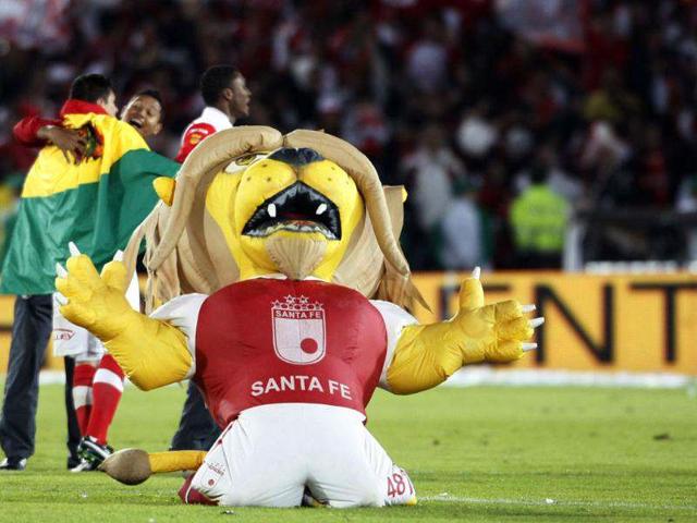 Independiente Santa Fe players and their mascot celebrate at the end of the Liga Postobon local soccer league tournament match against Deportivo Pasto in Bogota, Colombia. AP/Fernando Vergara