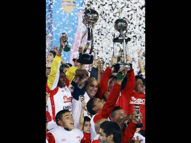 Independiente Santa Fe players celebrate at the end of the Liga Postobon local soccer league tournament match against Deportivo Pasto in Bogota, Colombia. AP/Fernando Vergara