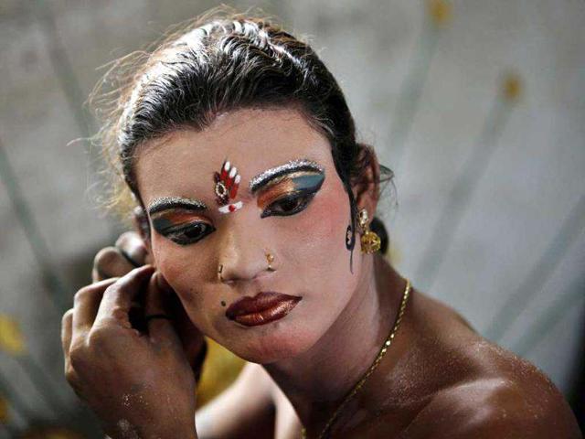 An artist gets ready before a performance during a procession of Bonalu festival in Hyderabad. AP/Mahesh Kumar A An artist gets ready before a performance during a procession of Bonalu festival in Hyderabad. AP/Mahesh Kumar A