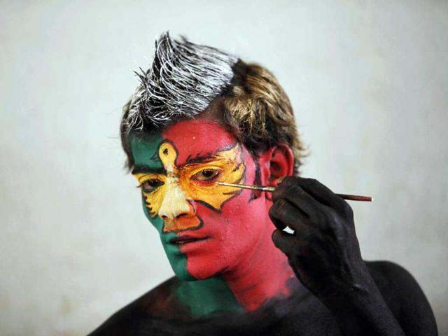 An artist applies make up before a performance. AP/Mahesh Kumar A An artist applies make up before a performance. AP/Mahesh Kumar A