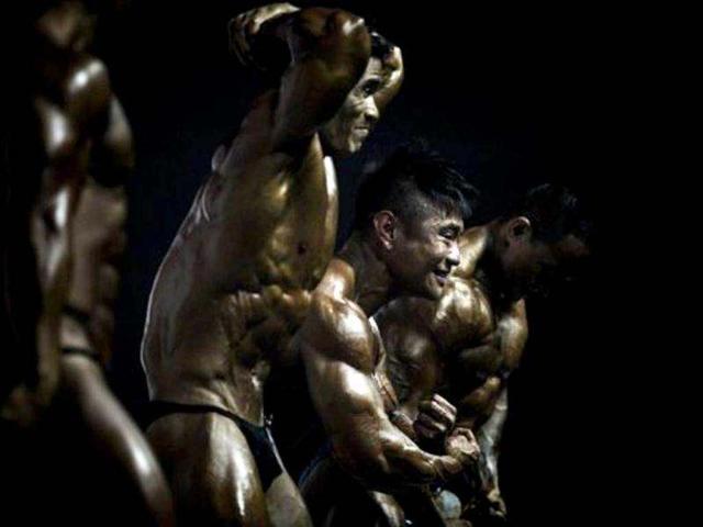Participants compete in the 2012 International Bodybuilding and Fitness Invitation Championship in Hong Kong. Participants do a series of mandatory poses and display their best shaped muscles to a panel of judges who assign points based on their appearance. AFP/Philippe Lopez