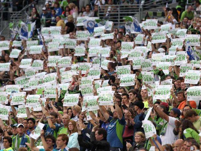 Fans hold signs bidding farewell to Roger Levesque #24 of the Seattle Sounders FC during the match against Chelsea FC at CenturyLink Field in Seattle, Washington. (Otto Greule Jr/Getty Images/AFP)