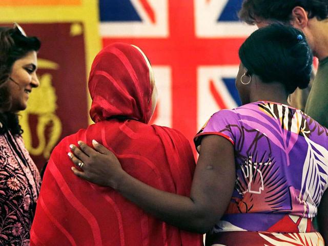 Rosemary Shav, a chaperone from Nigeria, right, puts her arm on the back of Nafeesa Rahman Qazi, of Northern Pakistan, while attending the "Common Bond" summer camp in Newbury, Massachusetts. Qazi, who is a community activist and works in a children's clinic in her homeland, lost two cousins to the Taliban. AP/Charles Krupa