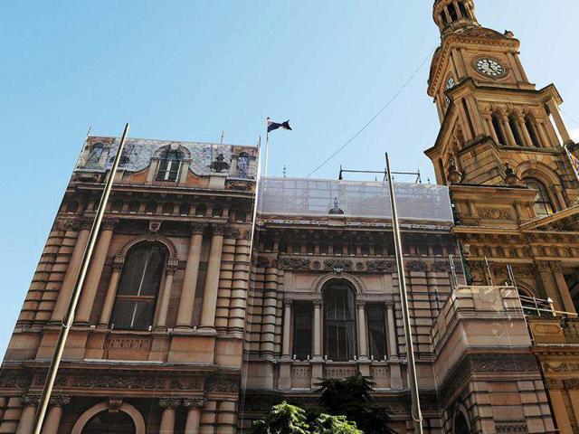 Sydney's iconic Town Hall building with its prominent sandstone facade is shown wrapped with a 20-metre-high mirror-image photograph, printed onto a custom-made mesh. AFP Photo/Greg Wood