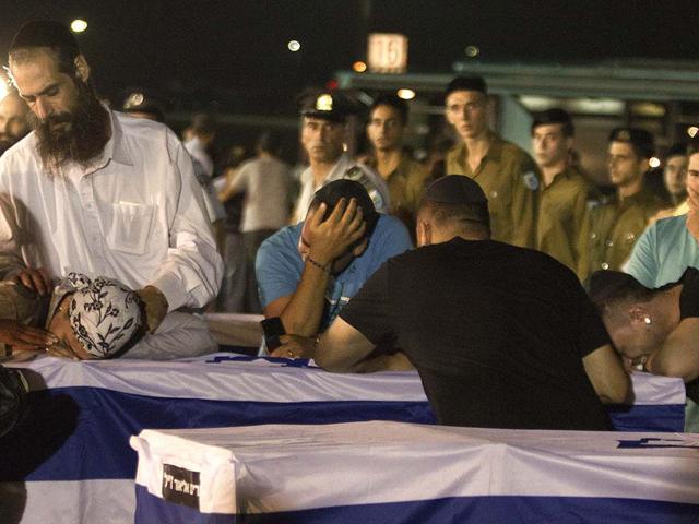 Relatives cry over a coffin of victims killed in bombing in Bulgaria after the remains arrived at Tel Aviv airport, Israel. A man carried out a deadly suicide attack on a bus full of Israeli vacationers in the Black Sea resort town of Burgas, a popular destination for Israeli tourist. AP/Dan Balilty
