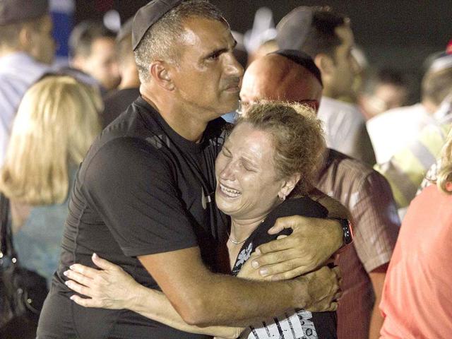 An Israeli family cries during a military ceremony for the victims who were killed in an attack in Bulgaria, at Tel Aviv airport, Israel. AP/Dan Balilty
