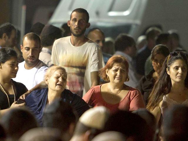 Relatives react after coffins of people killed in bombing in Bulgaria arrived to Tel Aviv airport, Israel. AP/Dan Balilty