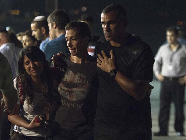 Relatives react as the coffins of people killed in a bombing in Bulgaria arrived back at an airport in Tel Aviv, Israel. AP/Dan Balilty