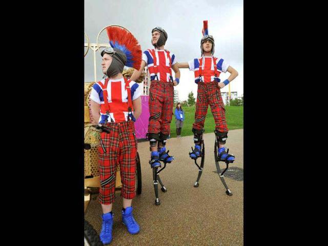 Members of the National Youth Theatre of Britain greet arriving athletes at their Olympic Village in east London with welcoming song and dance routines, one week ahead of the start of the London 2012 Olympic games. AP/John Stillwell