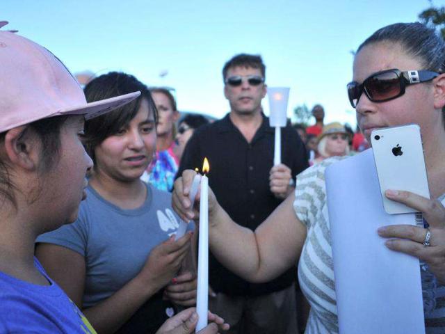 Mourners light candles at a memorial service in Aurora, outside of Denver, Colorado. (Thomas Cooper/Getty Images/AFP)