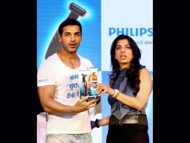 John Abraham poses with Aarushi Agarwal, Director Marketing, Consumer Lifestyle at Philip.