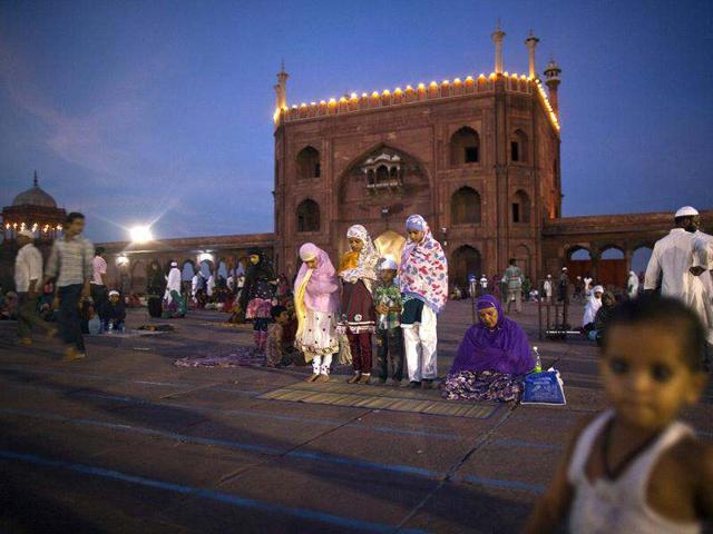 Muslims sit after having their Iftar (fast-breaking) meal during the holy month of Ramadan at the Jama Masjid (Grand Mosque) in the old quarters of Delhi. (Reuters)