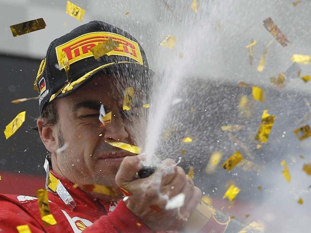 Ferrari Formula One driver Fernando Alonso of Spain celebrates after winning the German F1 Grand Prix at the Hockenheimring in Hockenheim. REUTERS/Alex Domanski Ferrari Formula One driver Fernando Alonso of Spain celebrates after winning the German F1 Grand Prix at the Hockenheimring in Hockenheim. REUTERS/Alex Domanski